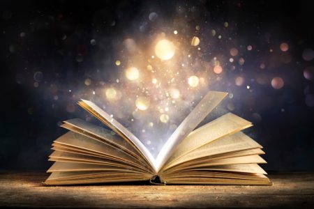Magic,Book,With,Open,Antique,Pages,And,Abstract,Bokeh,Lights